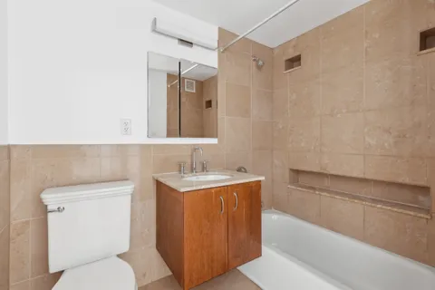 a bathroom with a toilet a sink and bathtub