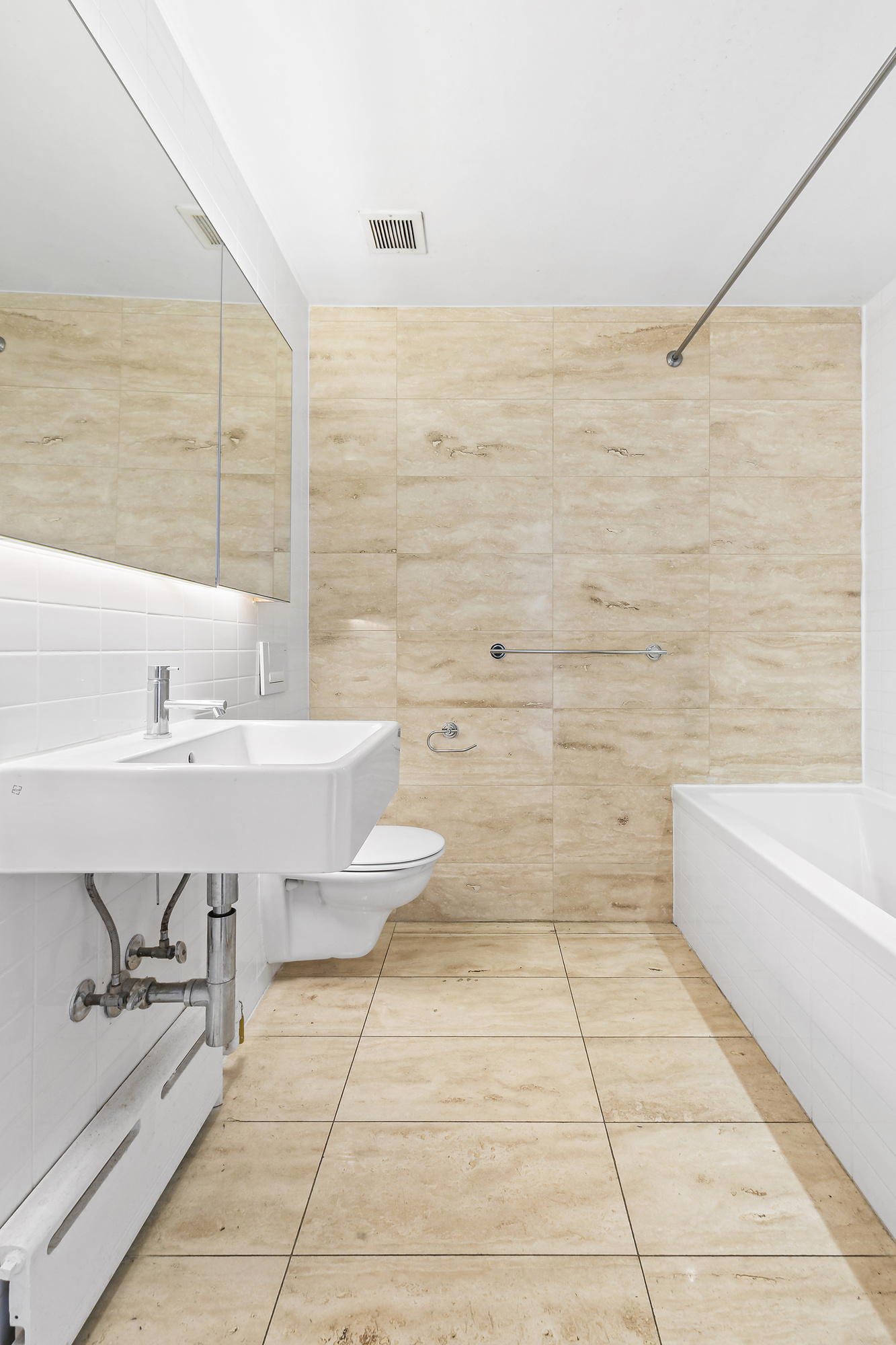 109 Norfolk Street, Unit 4 Manhattan, NY 10002 - Photo 6 of 7 a bathroom with a sink a bathtub and a shower