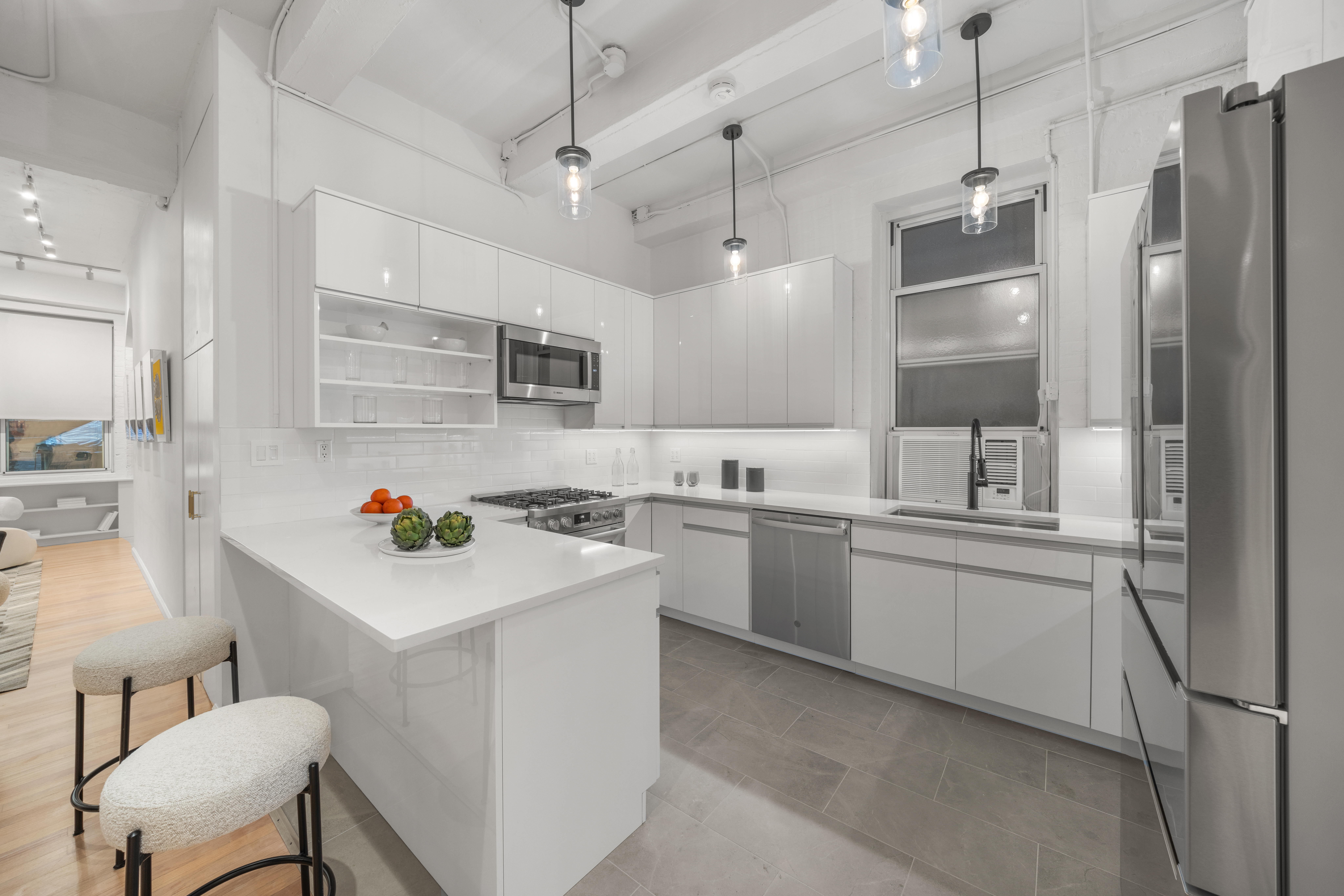 95 Vandam Street, Unit 2R Manhattan, NY 10013 - Photo 5 of 21 a kitchen with a sink and refrigerator