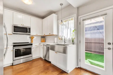 a kitchen with a stove a sink and a microwave