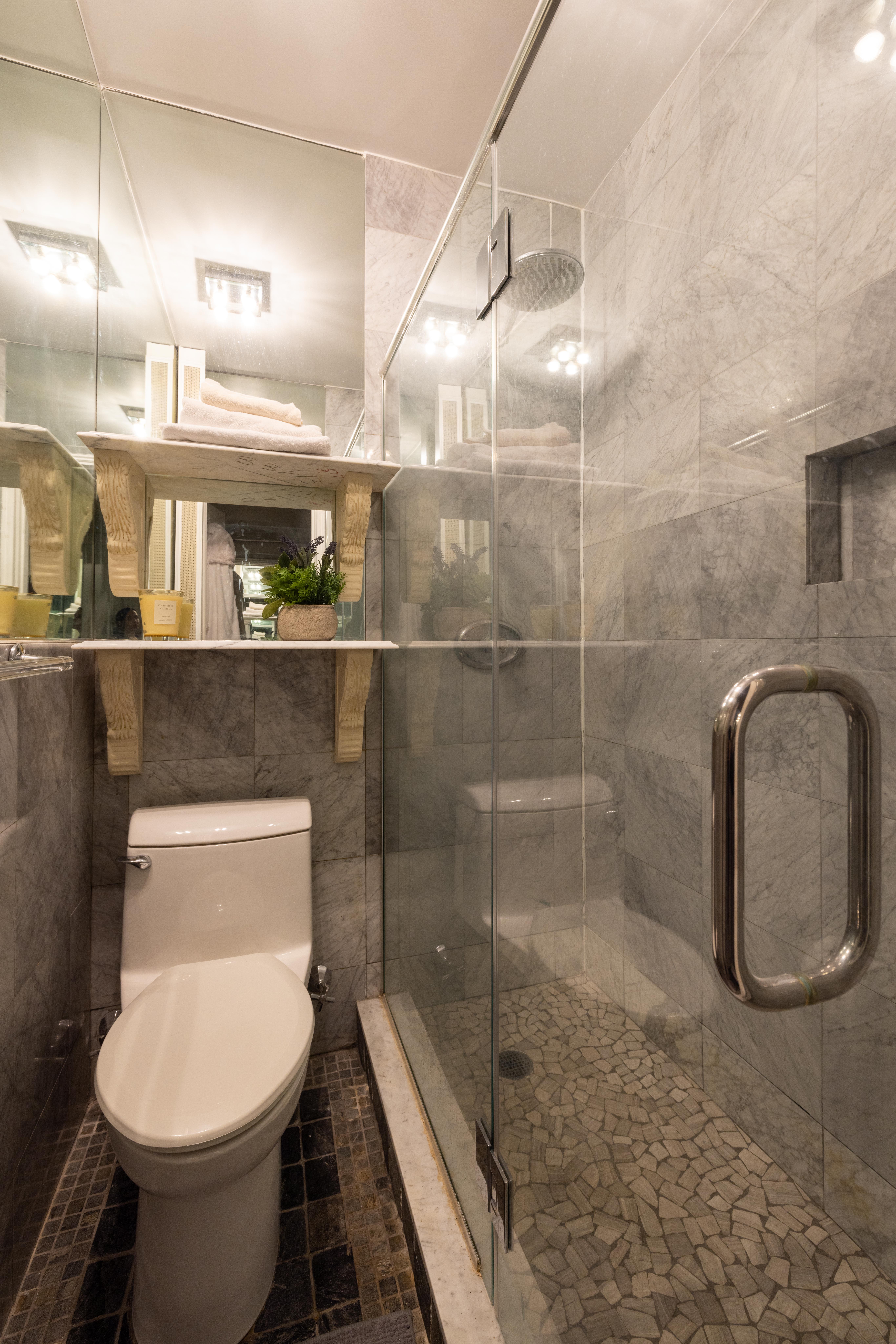 107 East 38th Street, Unit 2AB Manhattan, NY 10016 - Photo 9 of 13 a bathroom with a toilet a sink and mirror