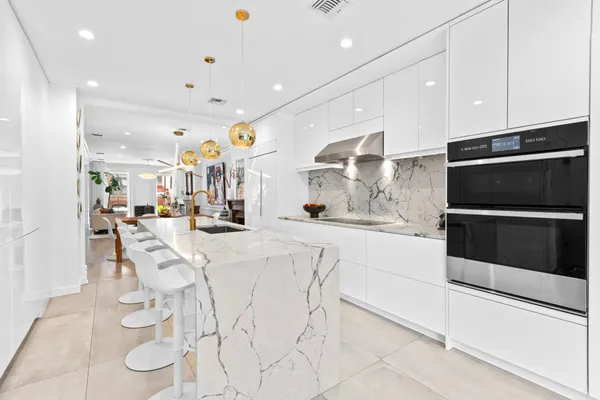 a kitchen with stainless steel appliances kitchen island granite countertop a sink and cabinets