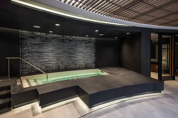 a room with stainless steel appliances granite countertop a sink a stove and a refrigerator