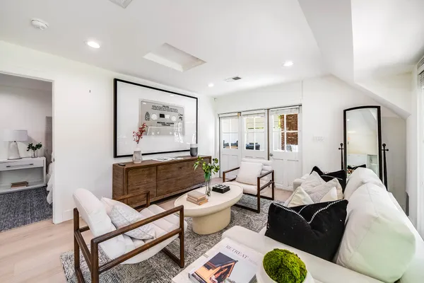 a living room with furniture and wooden floor