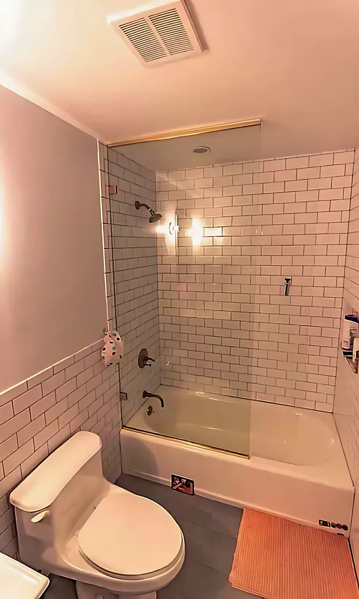 133 Essex Street, Unit 403 Manhattan, NY 10002 - Photo 5 of 7 a bathroom with a toilet a sink and bathtub