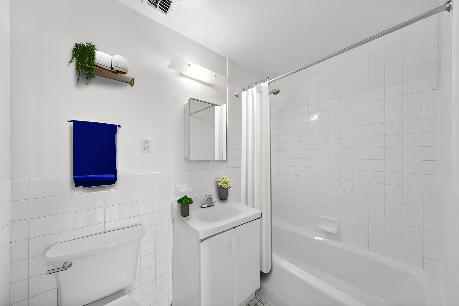 a bathroom with a bathtub a sink a toilet and shower