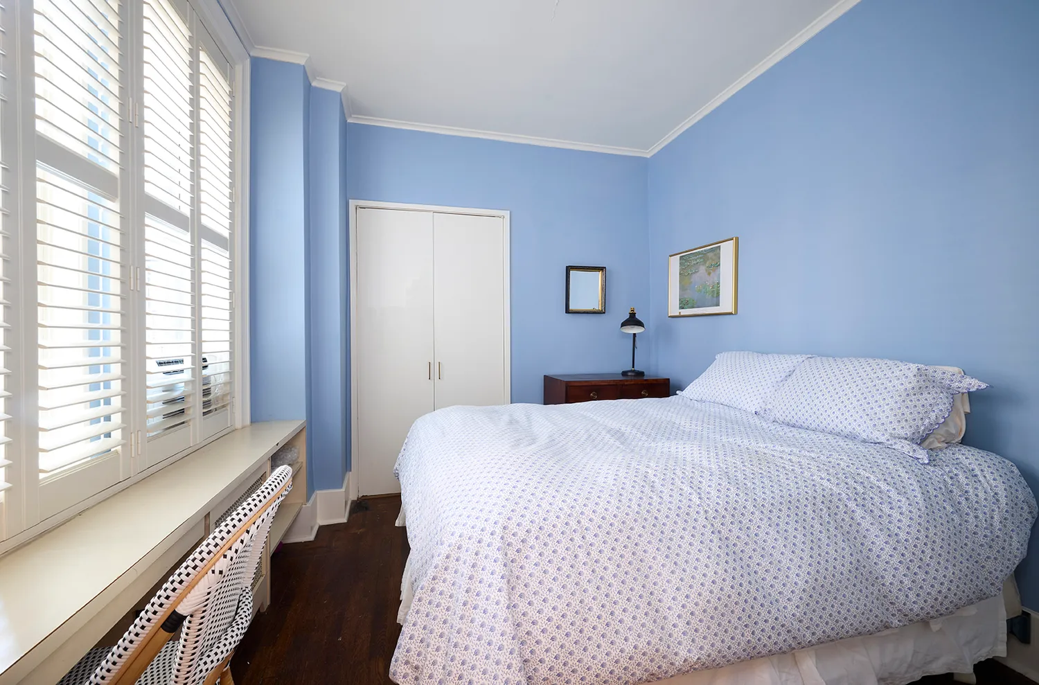 a bedroom with a bed and a large window with outer view