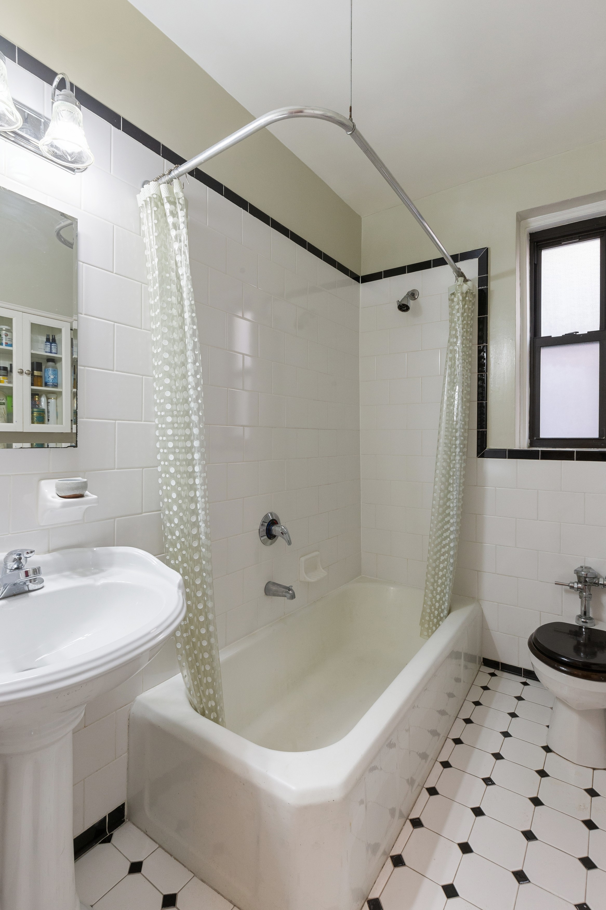 159-00 Riverside Drive West, Unit 5D Manhattan, NY 10032 - Photo 9 of 19 a bathroom with a sink a toilet and shower