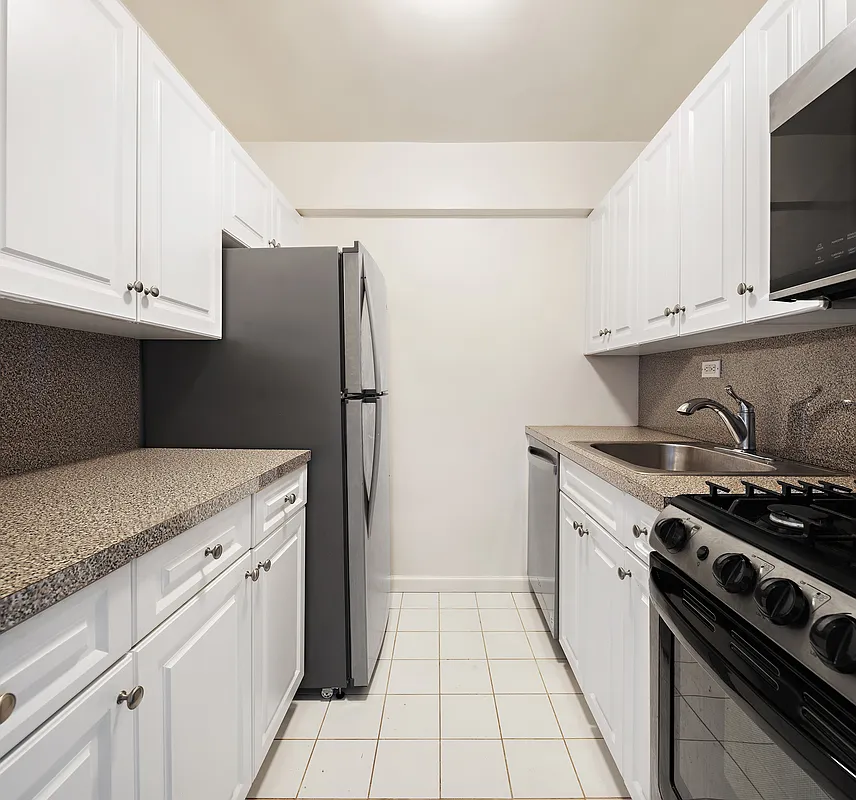 85 4th Avenue, Unit 4EE Manhattan, NY 10003 - Photo 3 of 7 a kitchen with a stove and a refrigerator