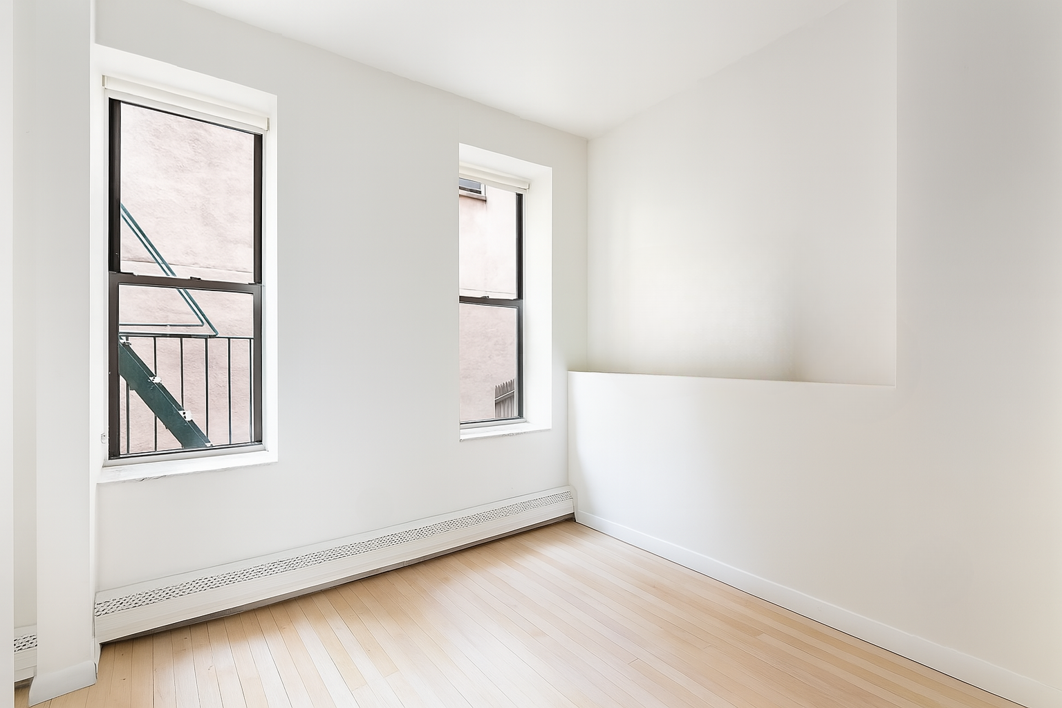 99 Avenue B, Unit 1B Manhattan, NY 10009 - Photo 3 of 8 an empty room with windows