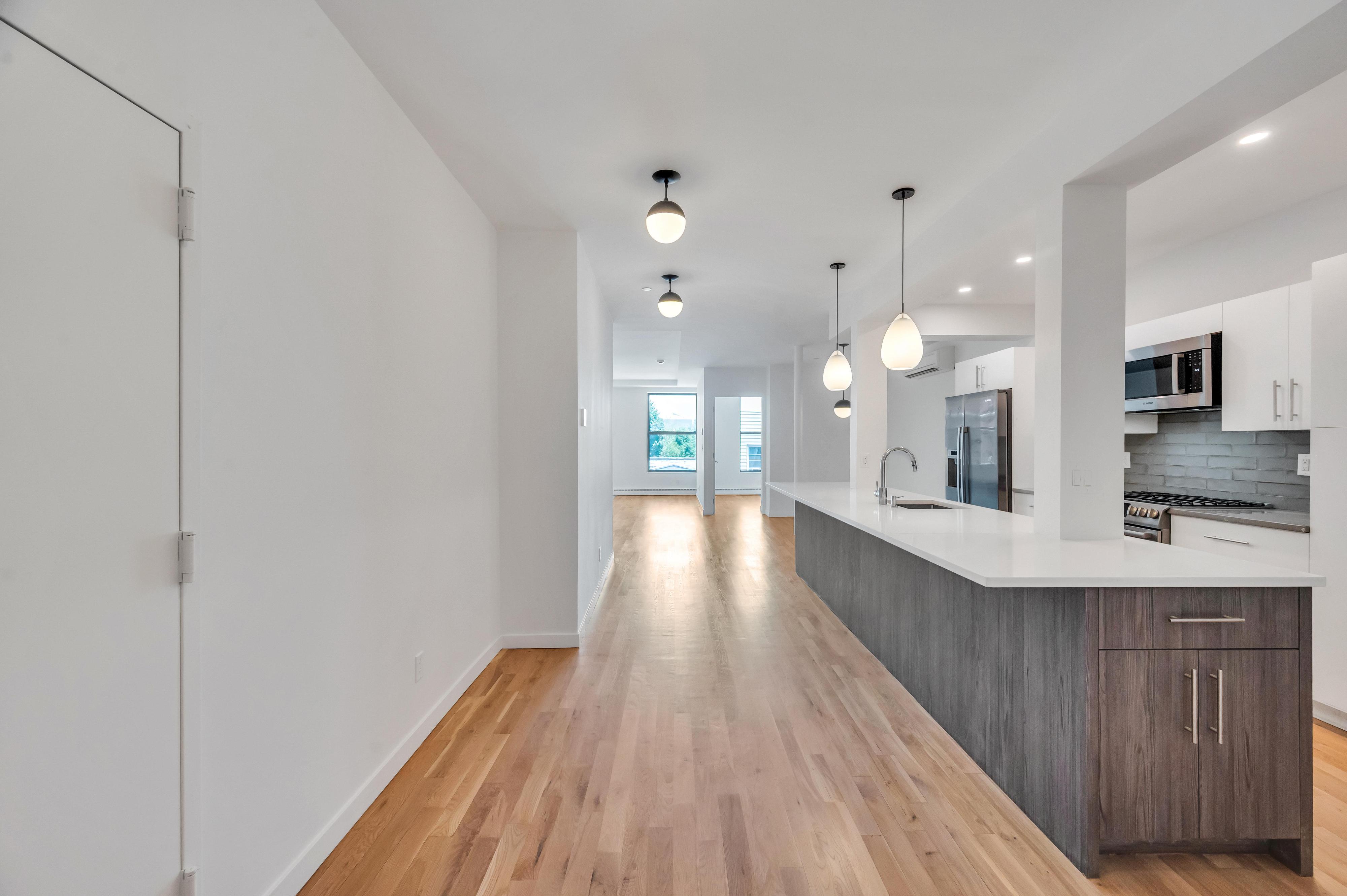 717 Manhattan Avenue, Unit 3A Brooklyn, NY 11222 - Photo 1 of 18 a view of a kitchen with a sink and wooden floor