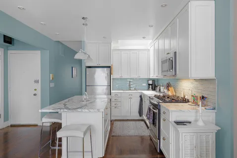 a kitchen with a sink stove and refrigerator