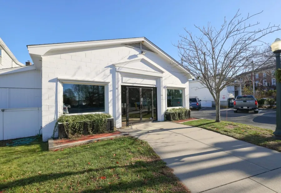 a front view of a house with garden and porch