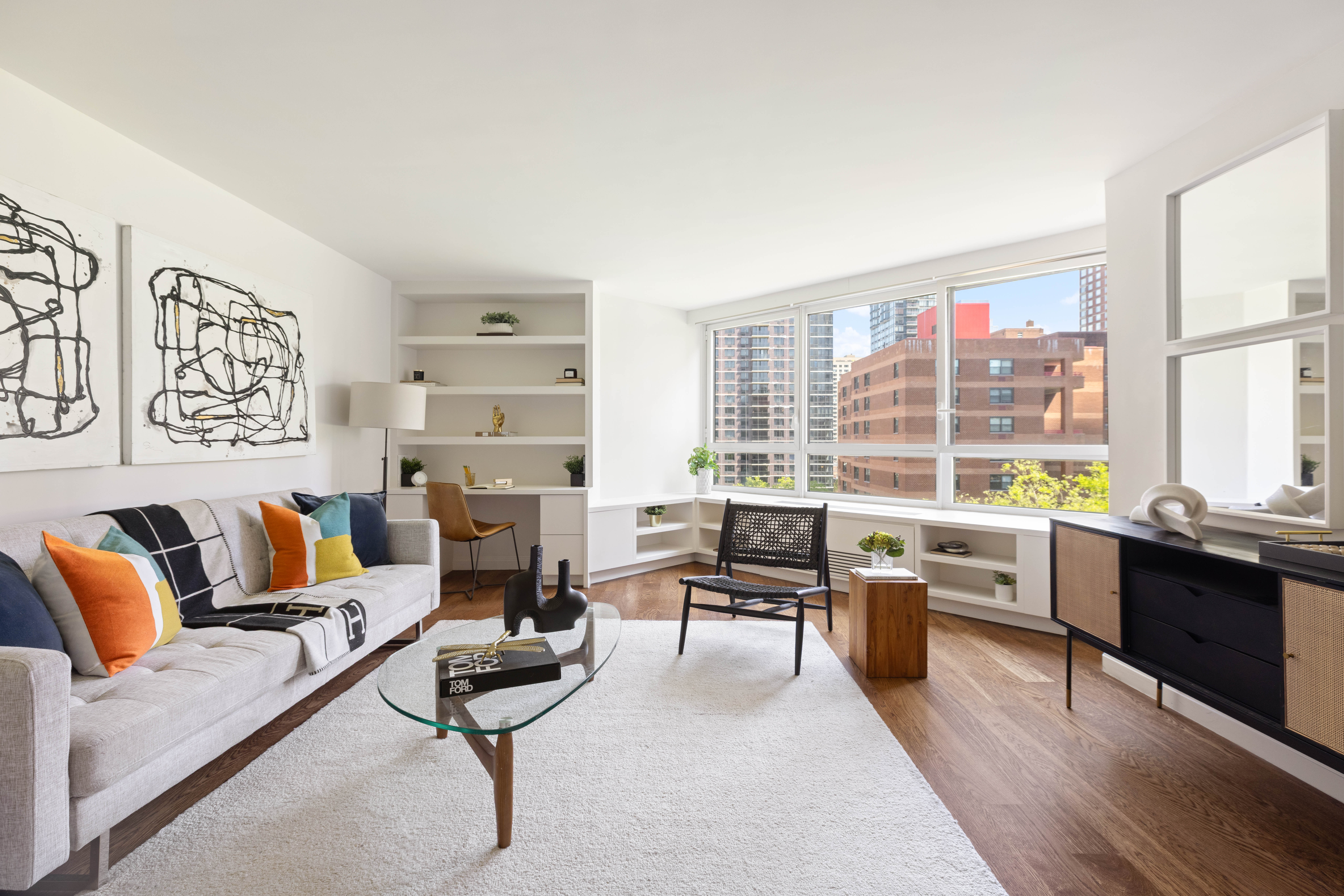 a living room with furniture large window and table