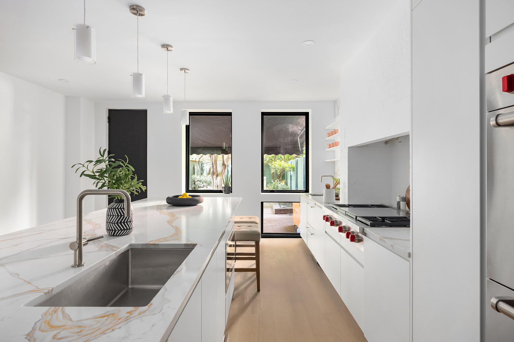 53 West 85th Street Manhattan, NY 10024 - Photo 11 of 37 a kitchen with granite countertop a stove and a sink