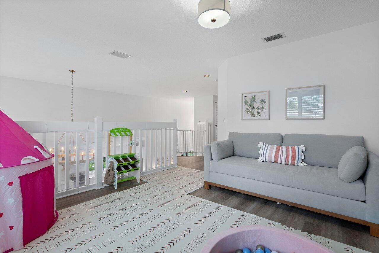 1182 Canoe Point Delray Beach, FL 33444 - Photo 23 of 46 a living room with furniture and wooden floor