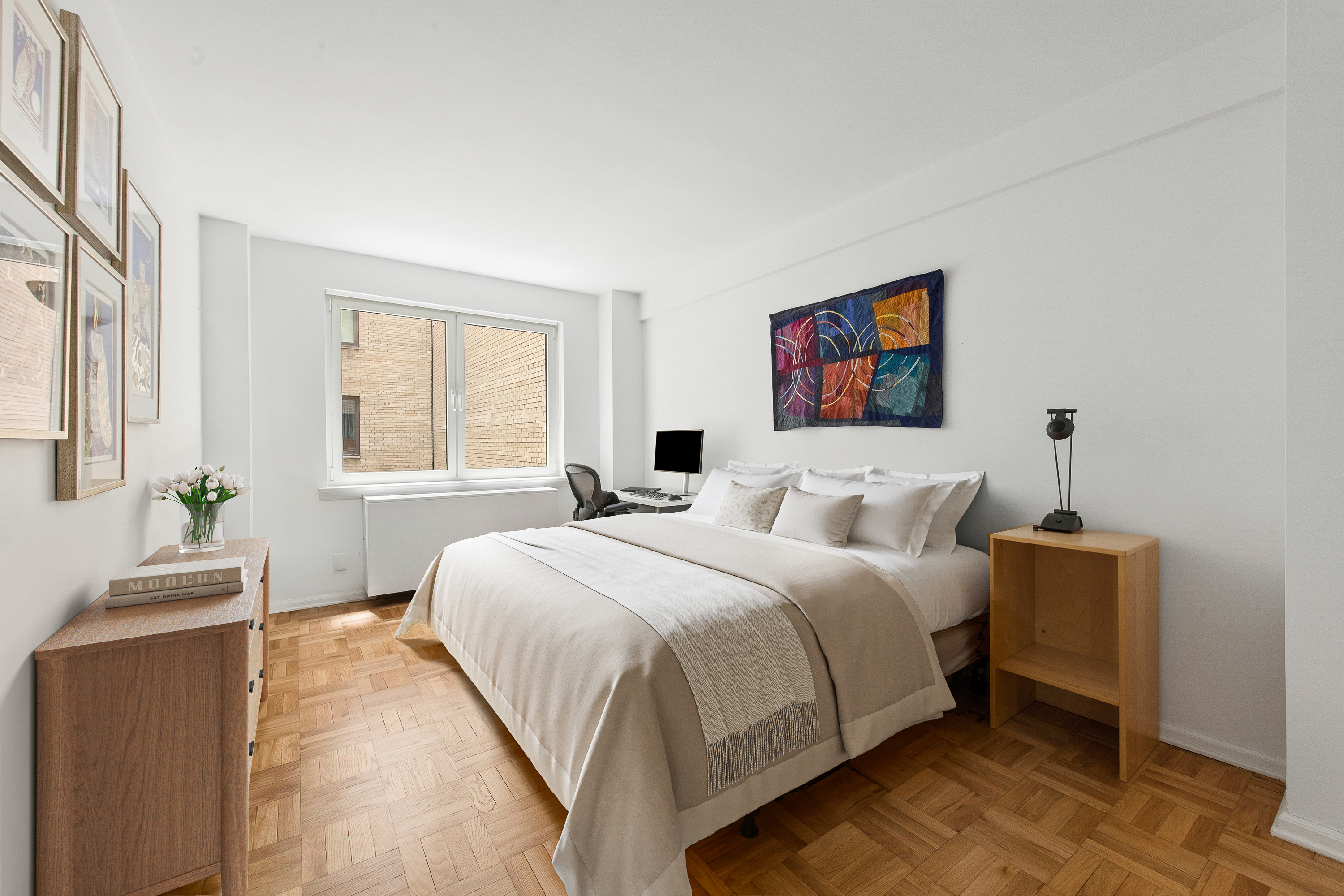 860 5th Avenue, Unit 3H Manhattan, NY 10065 - Photo 6 of 17 a bedroom with a large bed and a window