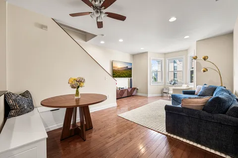 a living room with furniture and a wooden floor