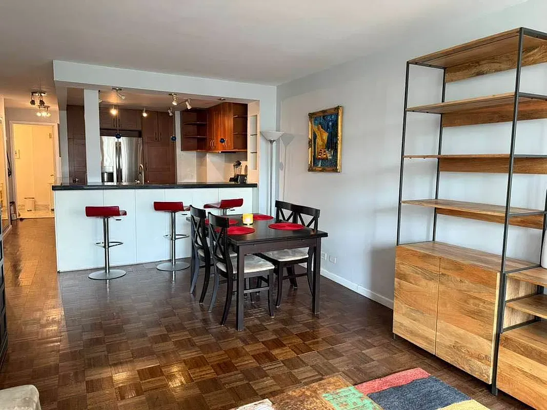 a dining room with furniture and window