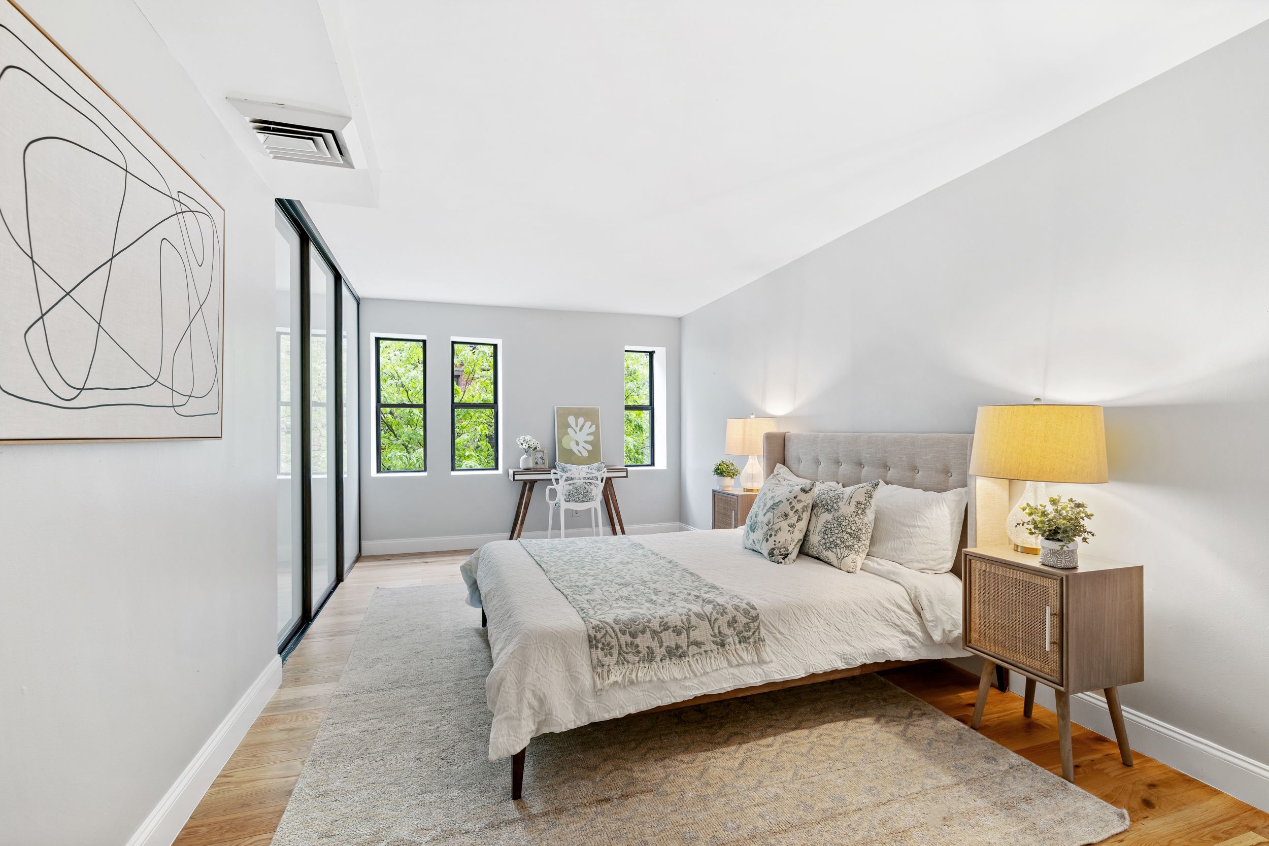 248 East 31st Street, Unit 4A Manhattan, NY 10016 - Photo 7 of 14 a bedroom with a bed and wooden floor