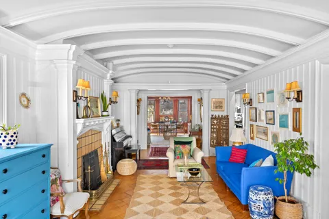 a living room with furniture and a potted plant