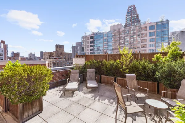 a view of a terrace with chairs and a table