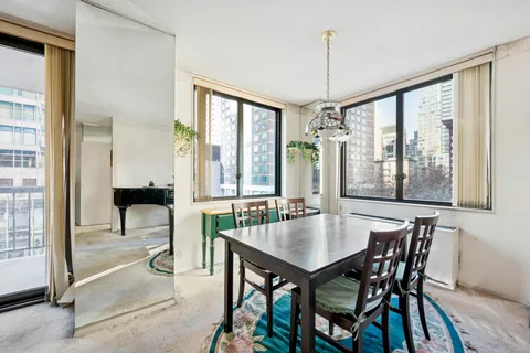 a dining room with furniture and window