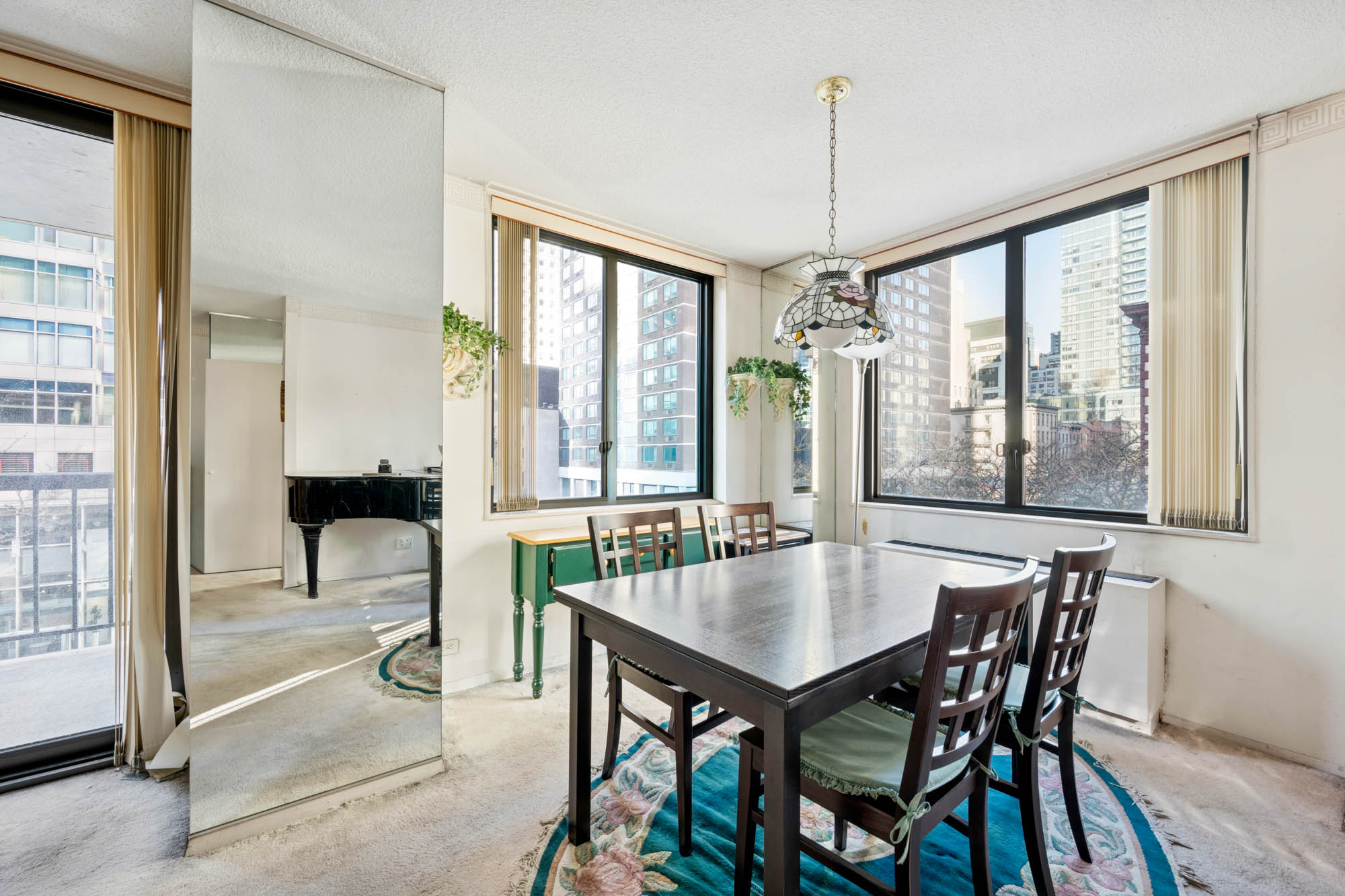 300 East 54th Street, Unit 3H Manhattan, NY 10022 - Photo 3 of 10 a dining room with furniture and window