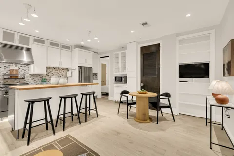 a bathroom with a sink a chair and a mirror