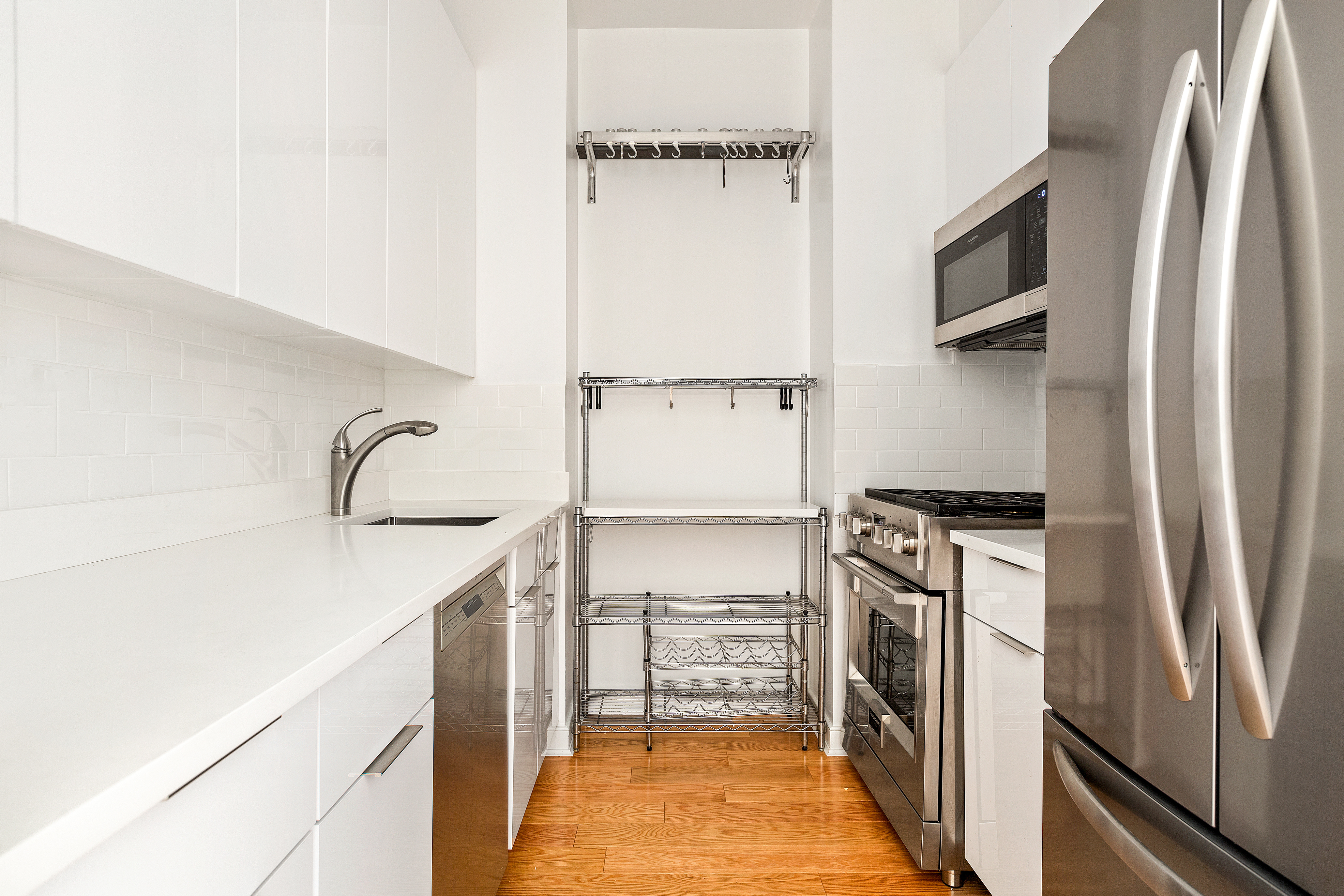120 East 87th Street, Unit R10C Manhattan, NY 10128 - Photo 3 of 13 a kitchen with a refrigerator and a sink