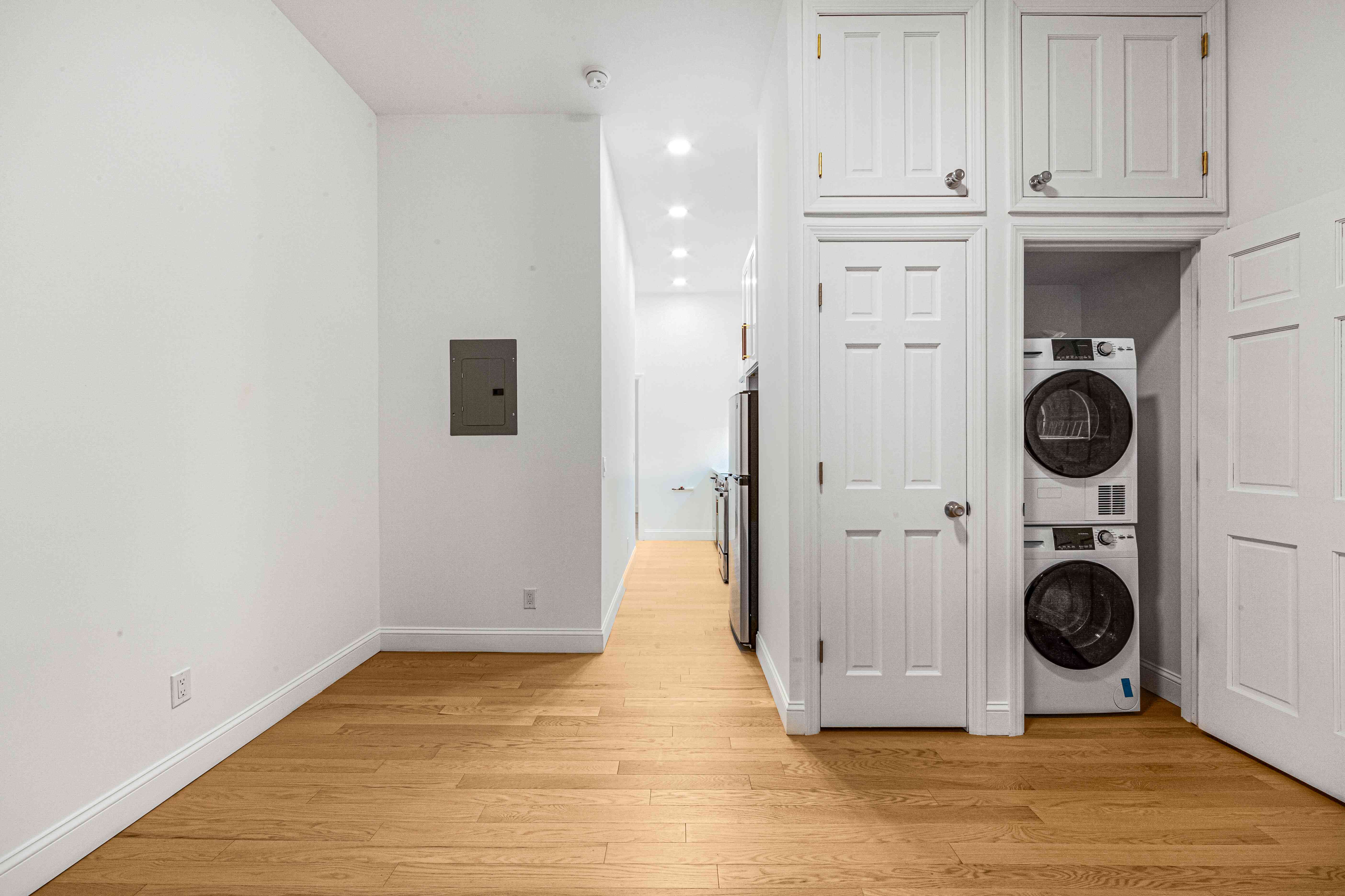 304 East 11th Street, Unit 1C Manhattan, NY 10003 - Photo 5 of 16 a view of a hallway with washer and dryer