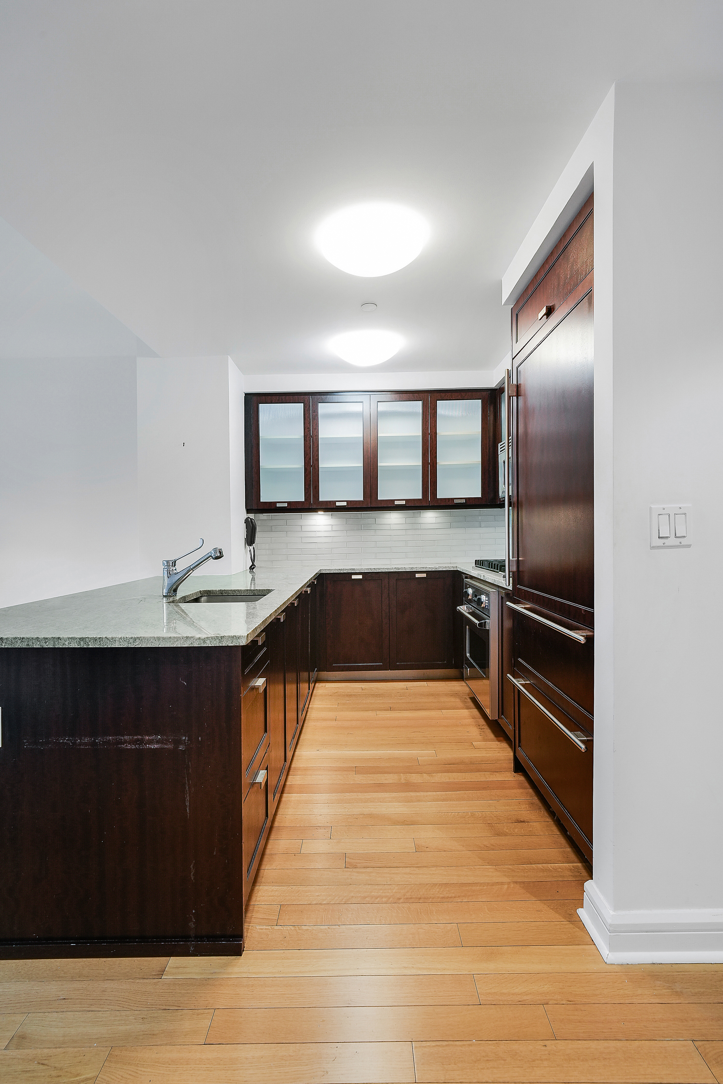 80 Riverside Boulevard, Unit 4H Manhattan, NY 10069 - Photo 7 of 17 a kitchen with granite countertop a refrigerator and a stove