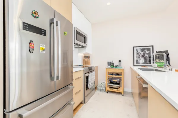 a kitchen with stainless steel appliances a refrigerator and a stove