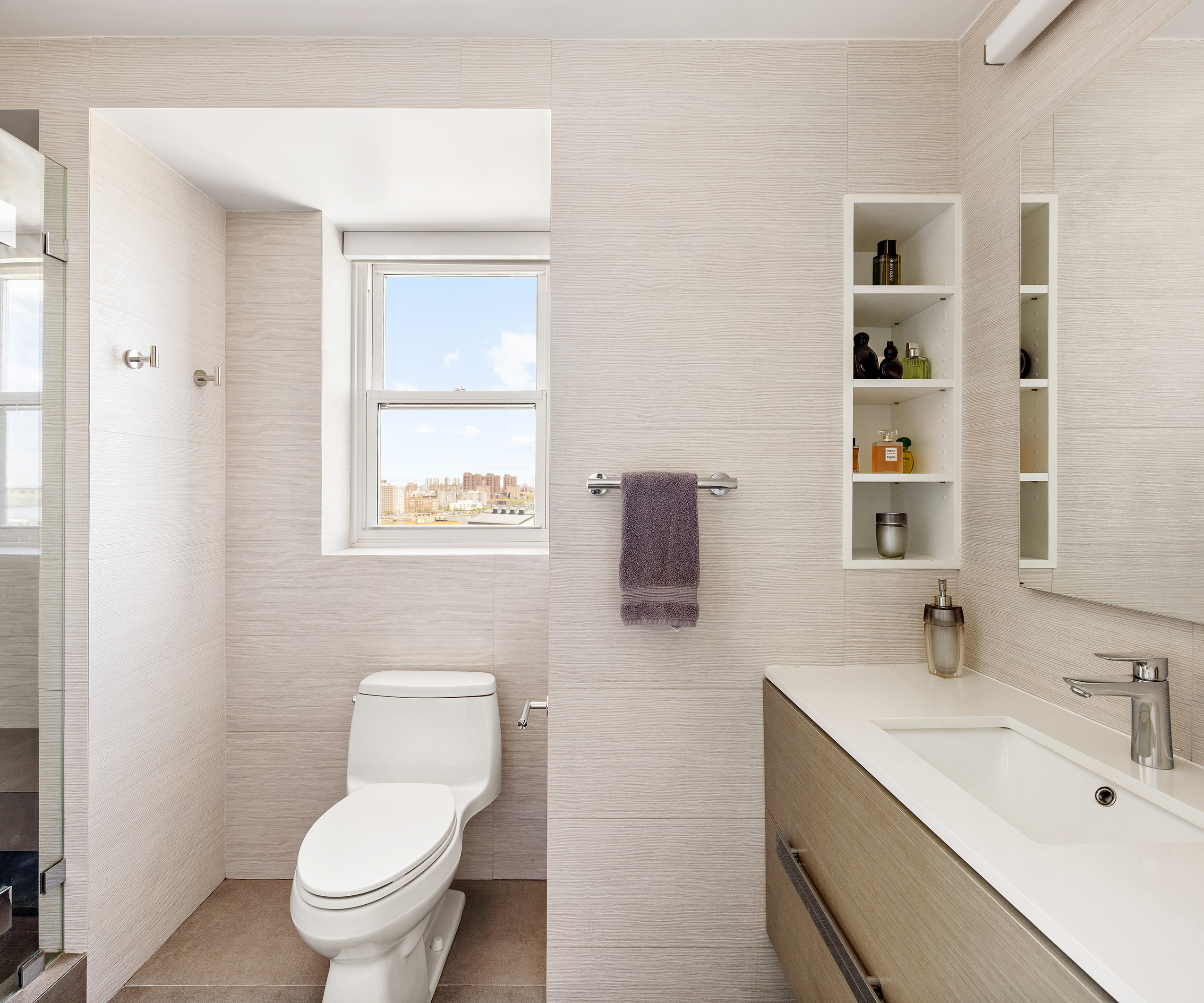 535 East 86th Street, Unit 16F Manhattan, NY 10028 - Photo 10 of 19 a bathroom with a toilet a sink and mirror