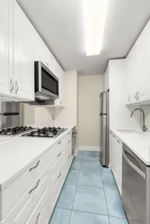 a kitchen with stainless steel appliances a stove sink and microwave