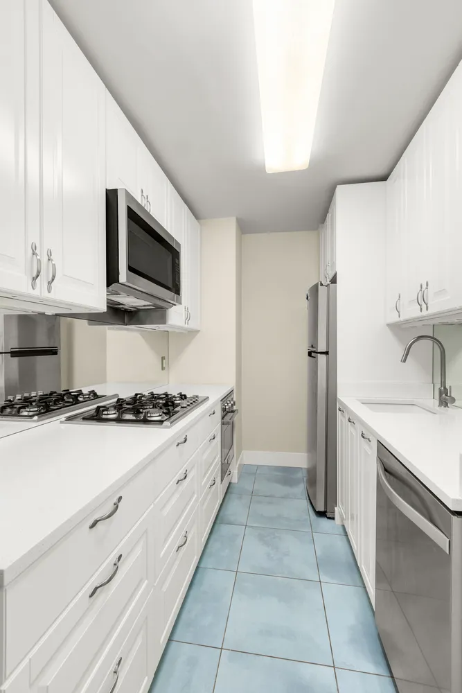 a kitchen with stainless steel appliances a stove sink and microwave