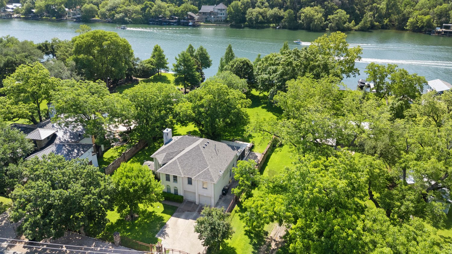 an aerial view of a house with a garden and lake view