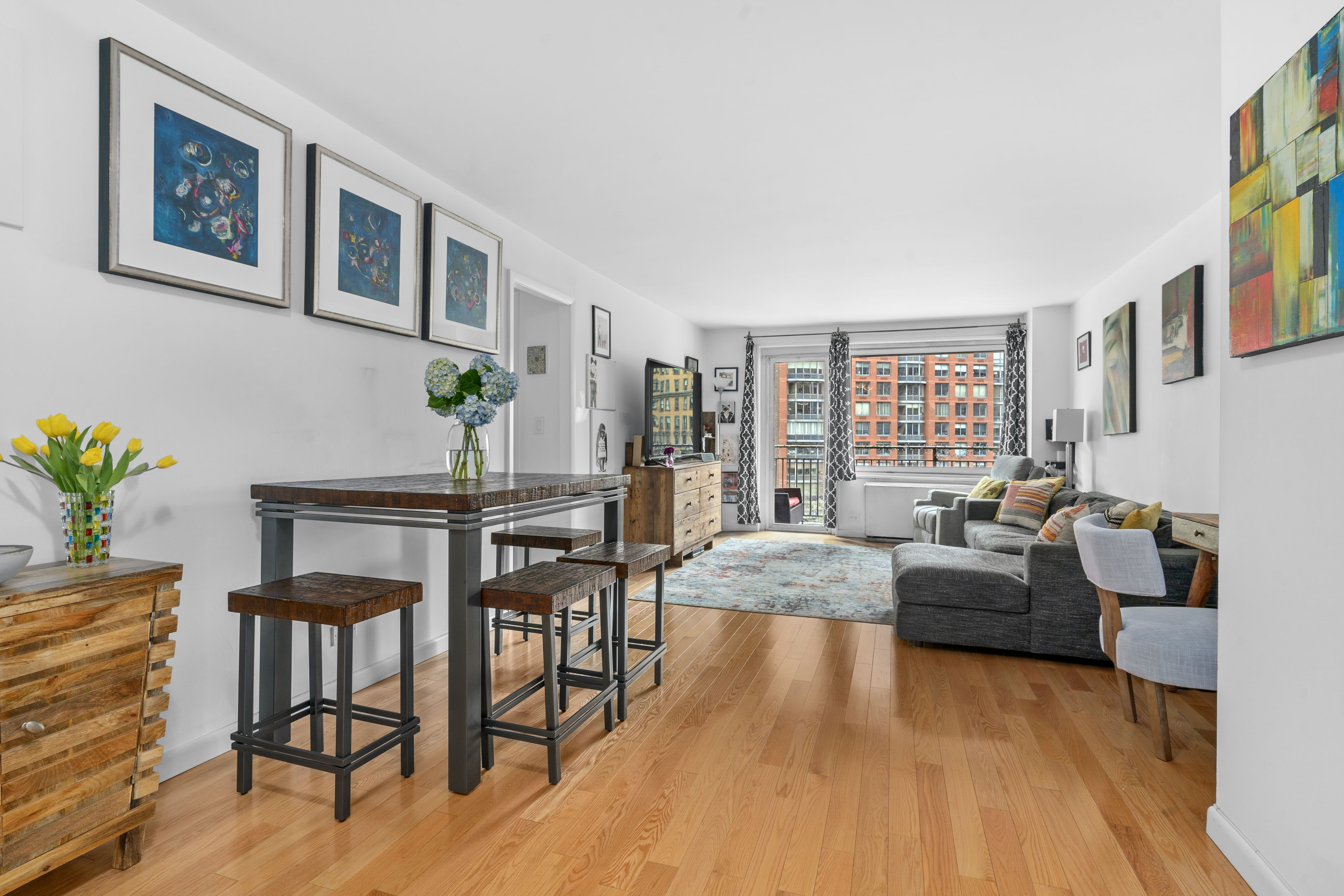 201 West 70th Street, Unit 7H Manhattan, NY 10023 - Photo 2 of 15 a living room with furniture and a wooden floor