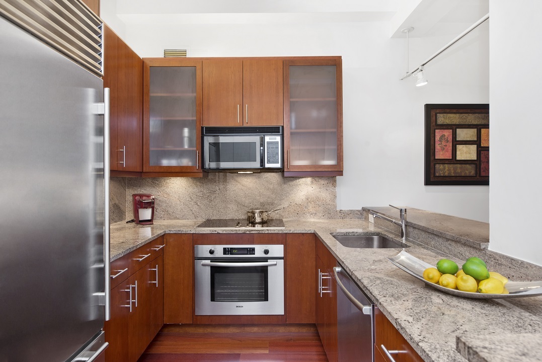 80 John Street, Unit 5G Manhattan, NY 10038 - Photo 2 of 8 a kitchen with stainless steel appliances granite countertop a sink a stove and a microwave