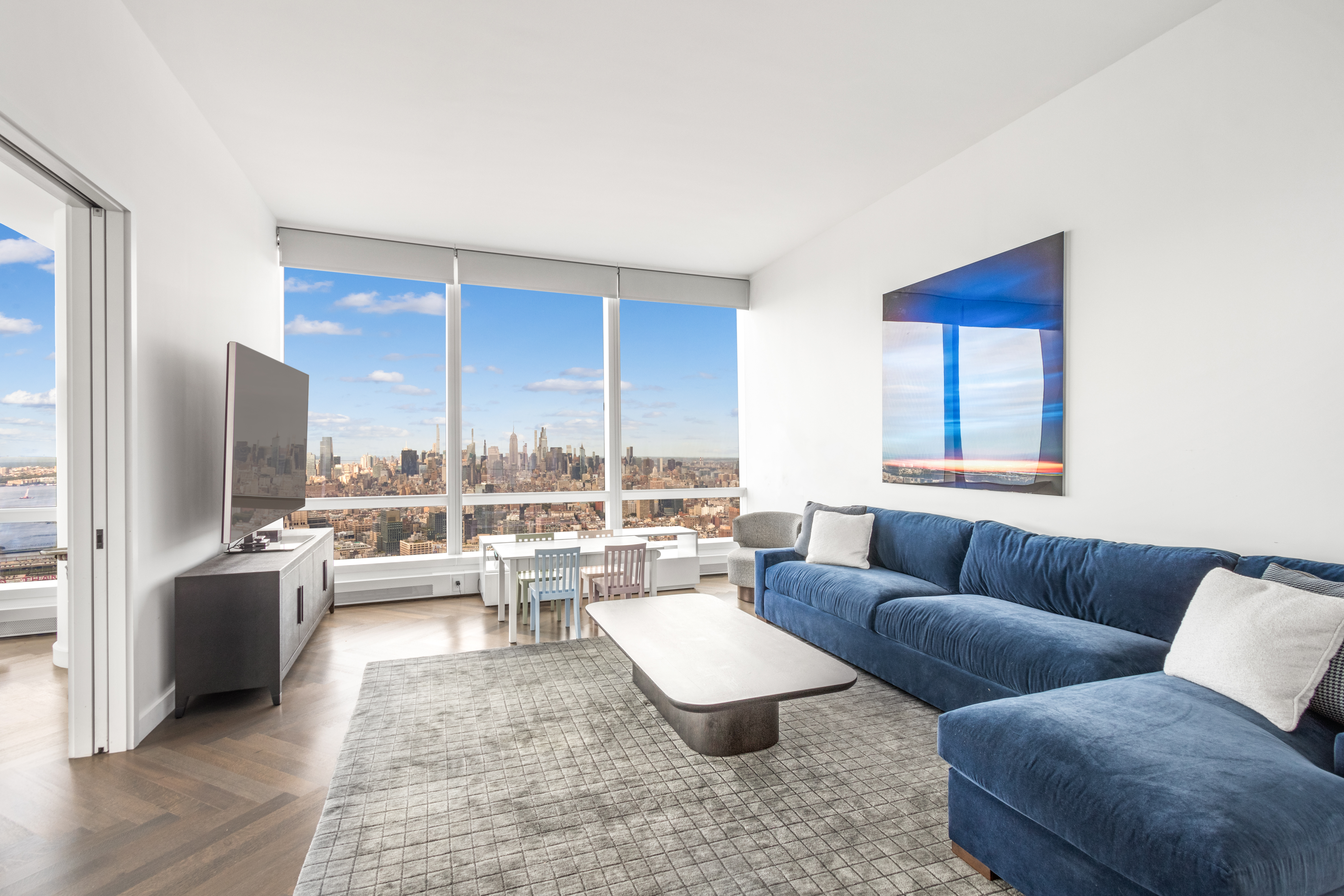 111 Murray Street, Unit 61W Manhattan, NY 10007 - Photo 18 of 35 a living room with furniture wooden floor and a large window