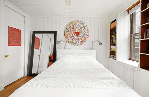 a bedroom with a large bed and a large window