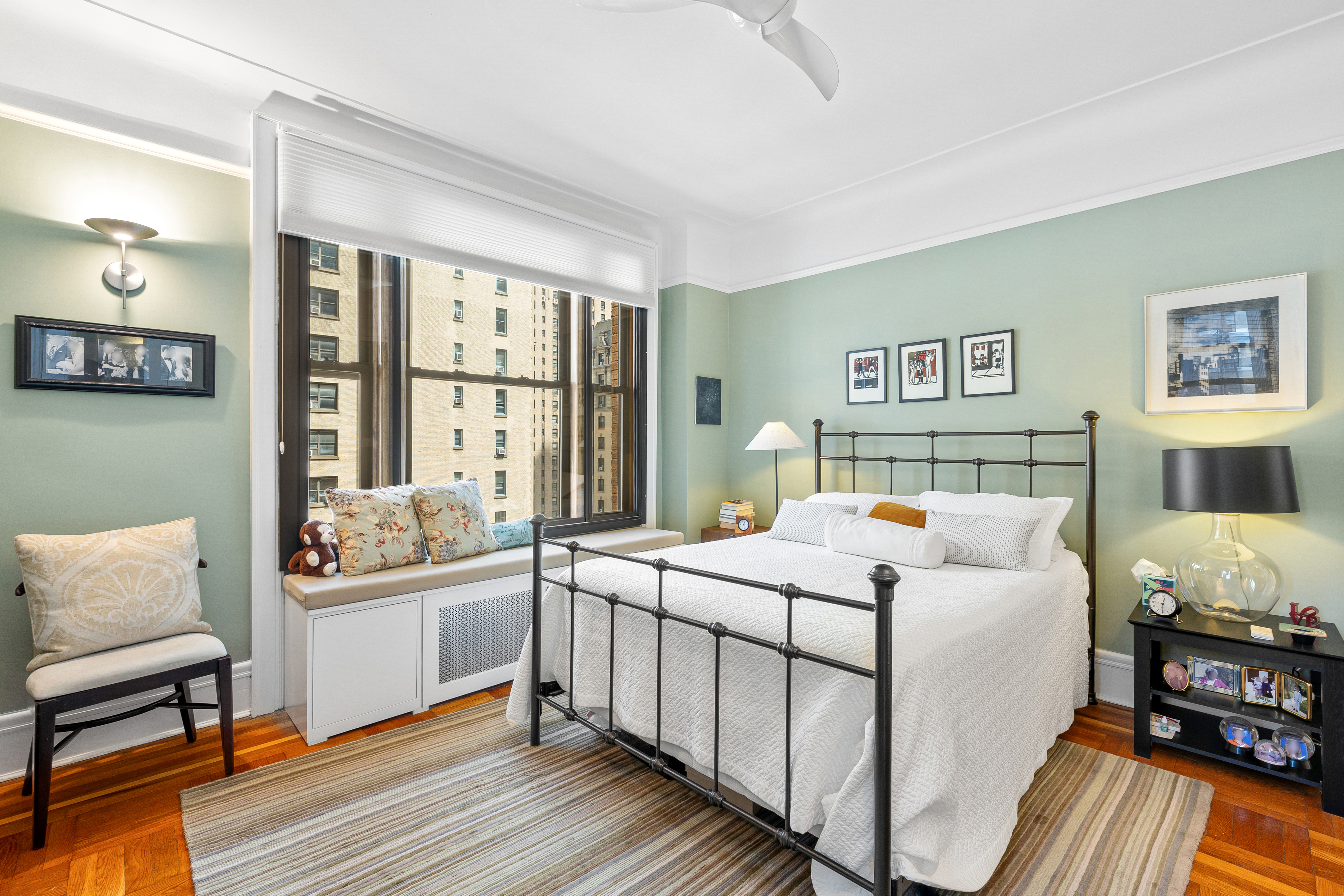 200 West 54th Street, Unit 9G Manhattan, NY 10019 - Photo 8 of 17 a bedroom with a bed and wooden floor