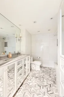 a bathroom with a sink a toilet and a mirror