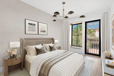 a bedroom with two beds and a large window with the outer view