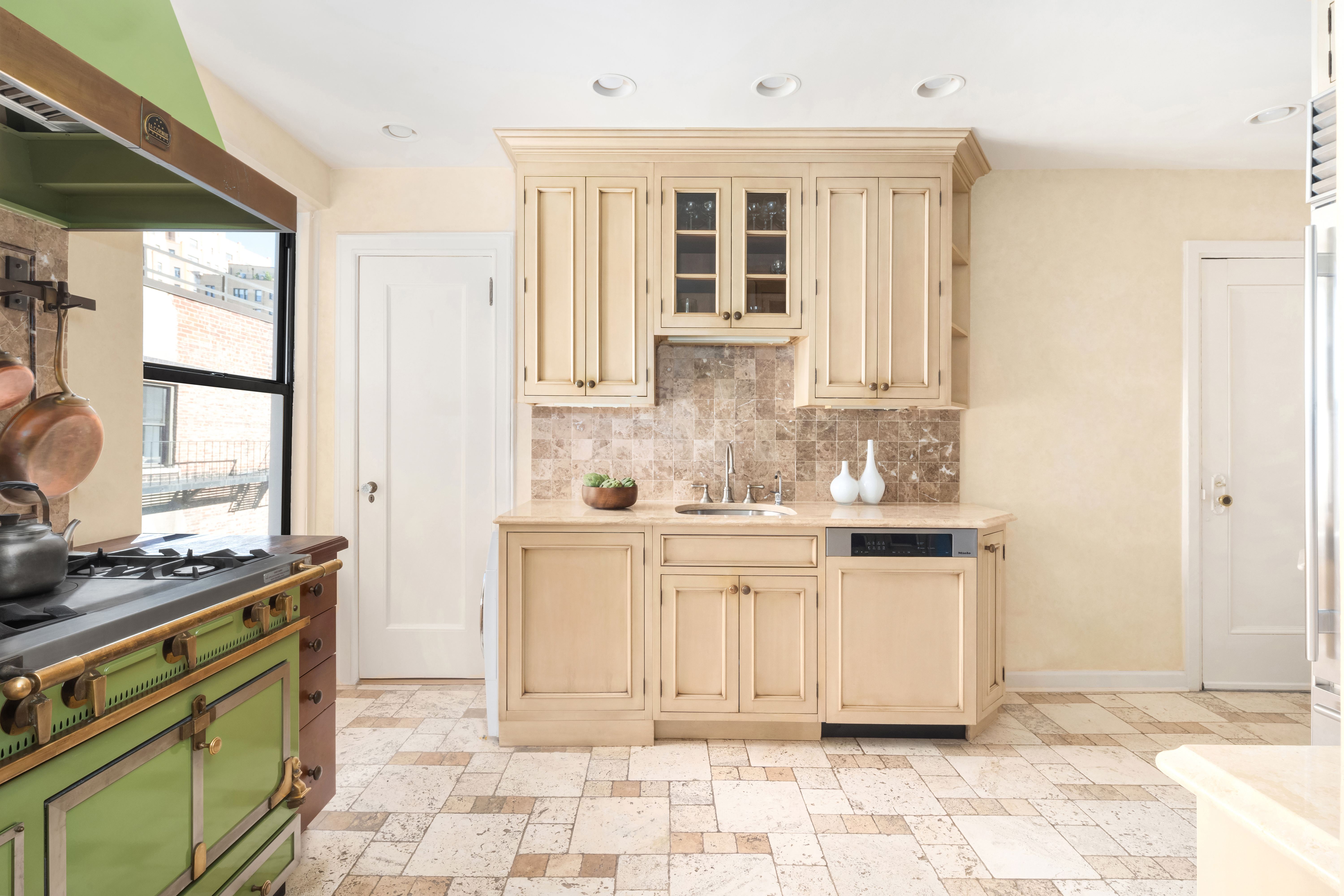 41 West 82nd Street, Unit 9D Manhattan, NY 10024 - Photo 7 of 15 a kitchen with stainless steel appliances granite countertop a stove a sink and a refrigerator