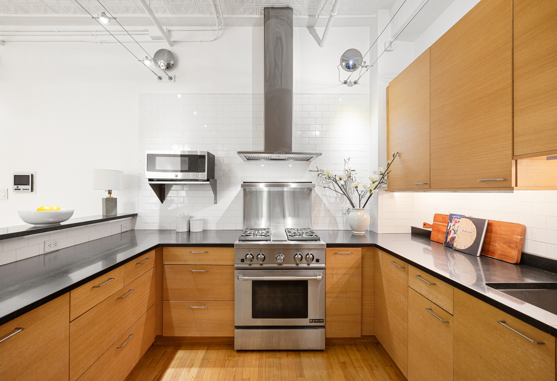 107 West 25th Street, Unit 5B Manhattan, NY 10001 - Photo 5 of 16 a kitchen with stainless steel appliances granite countertop a stove and a sink