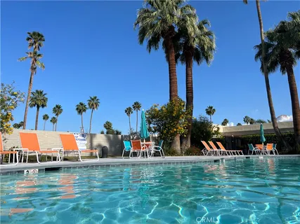a view of a swimming pool with a table and chairs
