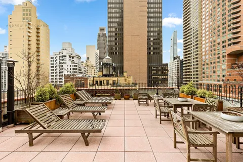 a view of balcony with chairs and lounge chair