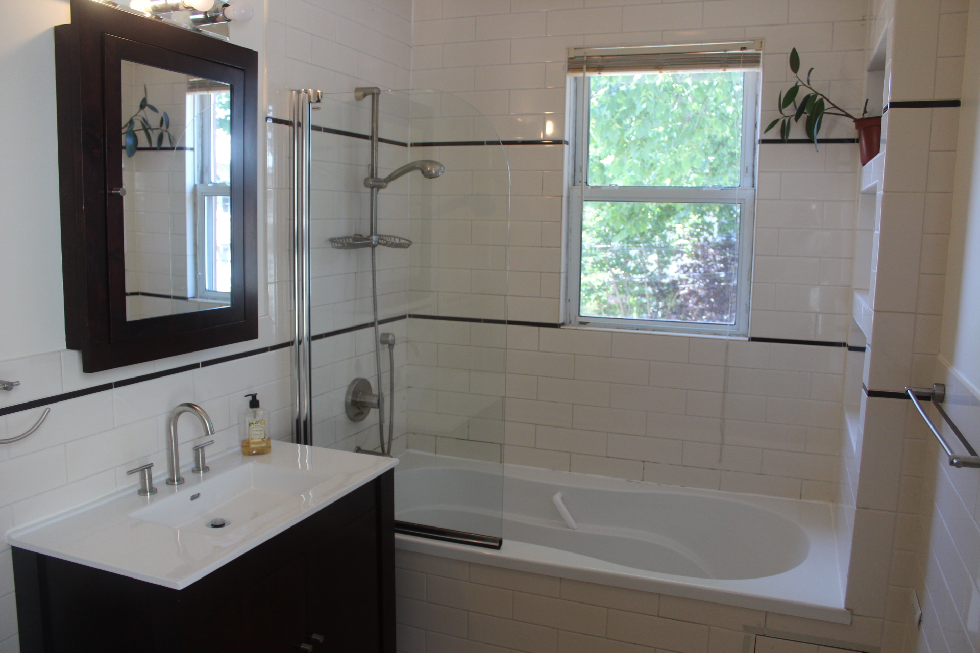 310 East 4th Street, Unit 2 Brooklyn, NY 11218 - Photo 7 of 11 a white bath tub sitting next to a bathroom sink