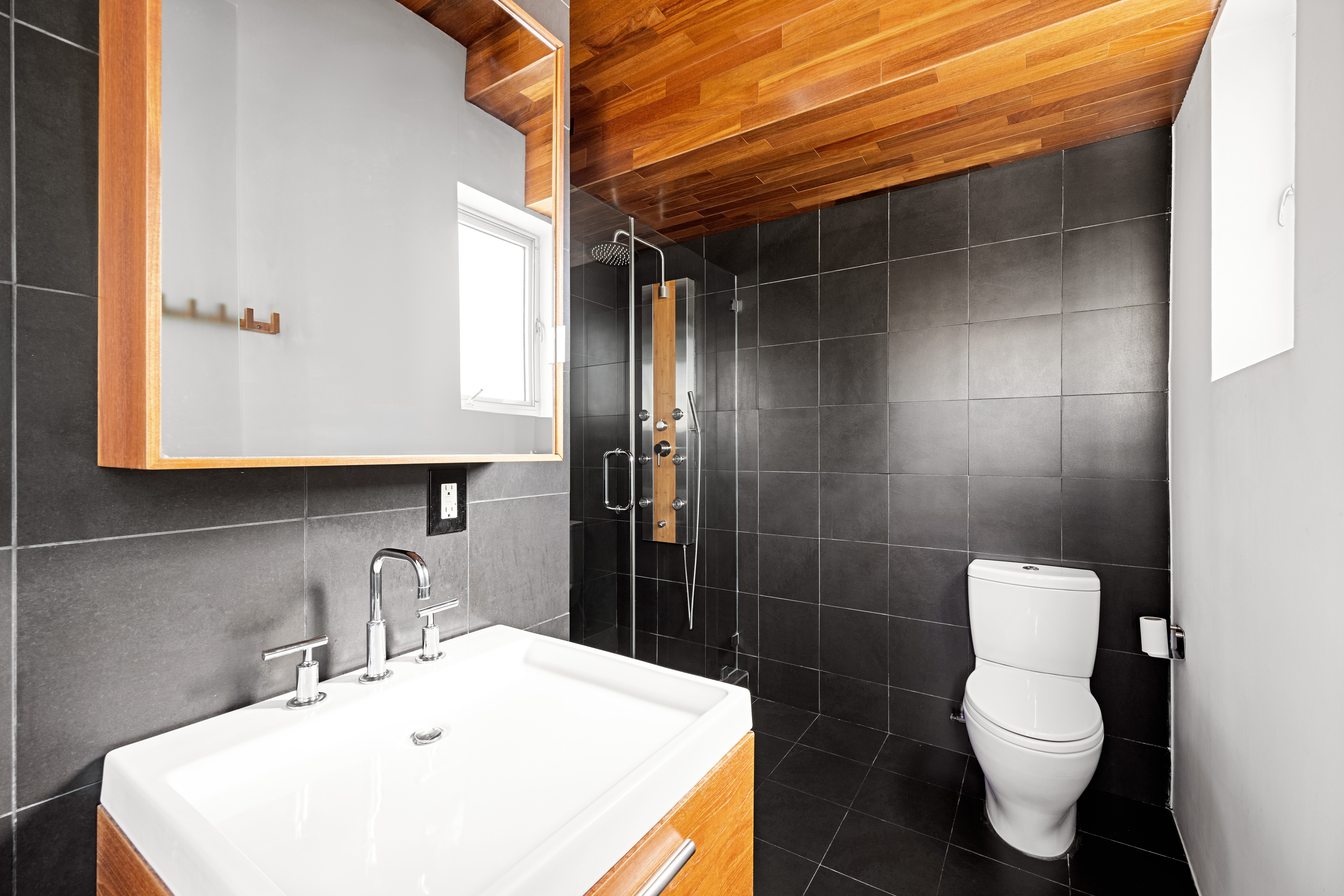 481 18th Street, Unit PH Brooklyn, NY 11215 - Photo 9 of 11 a bathroom with a sink toilet and shower